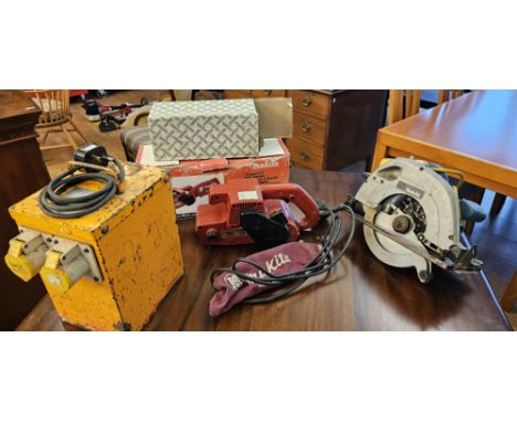 A Makita 240v M992 belt sander with sand paper and a 110v Makita circular saw with power pack