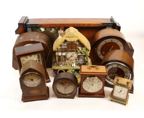 A collection of mid 20th century and later mantel clocks, having manual wind and quartz movements, in two boxes. (2)