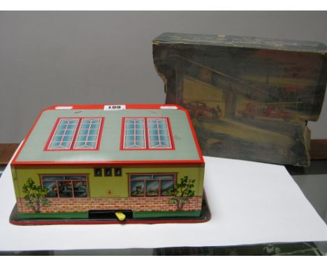 A Post War West German Tinplate Fire Station, with two plastic fire engines, in poor box and one engine damaged.