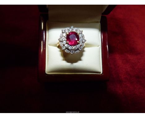 An 18ct gold ring set with 24 diamonds, central ruby and diamond chips, size K.