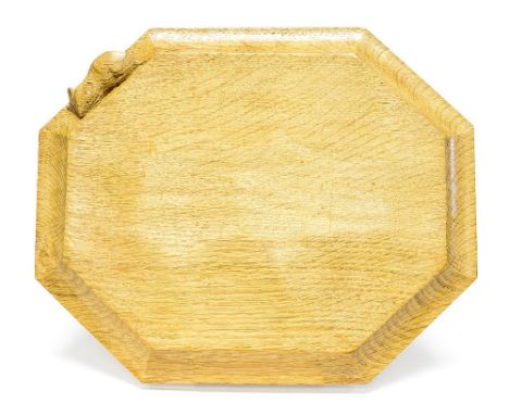 A Robert 'Mouseman' Thompson of Kilburn, a carved oak bread or chopping board, octagonal form with adzed surface, 30cm x 25cm