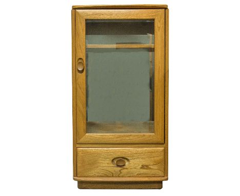 An Ercol Windsor glazed pedestal cabinet, light elm, the single glass door over a single drawer, 50cm wide, 99cm high, 48cm d