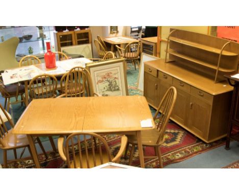 A light oak Priory dining set including pull out table, four stick back chairs and sideoboard, in the style of Ercol