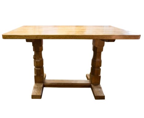 Robert Mouseman Thompson of Kilburn, an Arts and Crafts style carved oak dining table of small proportions, the adzed top sup