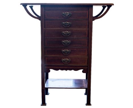 An Arts and Crafts mahogany and inlaid music cabinet, in the Glasgow style, fitted with six drawers below a bracketed shelf t