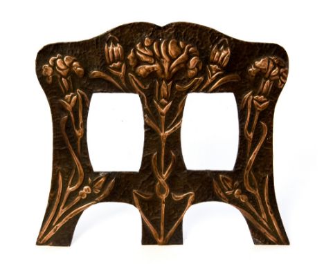 An Art Nouveau copper double photo frame, ogee form, repousse decorated with cornflower or iris motifs, the openings 9cm x 6.