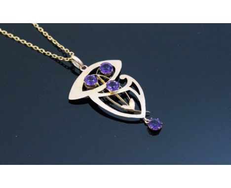 An Arts and Crafts 9 carat gold and amethyst pendant on chain, in the Art Nouveau style, the fretted scrollwork body with fin