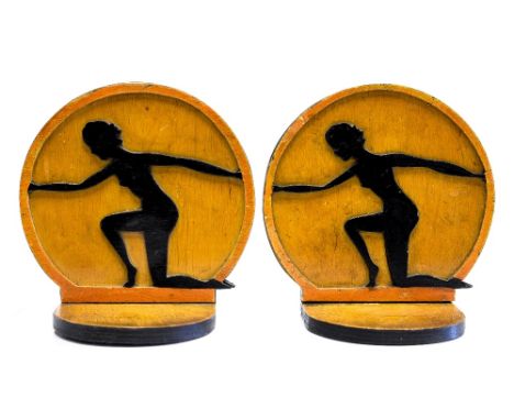 A pair of Art Deco caved wooden bookends, in the form of two silhouettes of women in athletic poses, 15cm high (2)