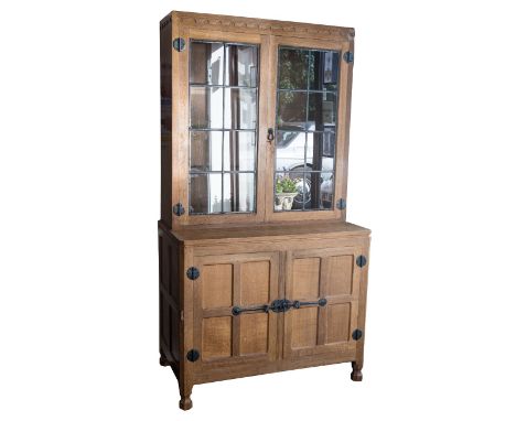 Robert Mouseman Thompson of Kilburn, an Arts and Crafts style carved oak bookcase cabinet, or dresser, of small proportions, 