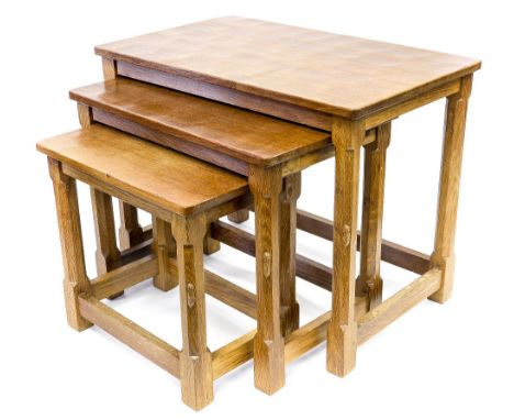 Robert Mouseman Thompson of Kilburn, a nest of Arts and Crafts style carved oak tables, each with adzed tops, the largest 61c