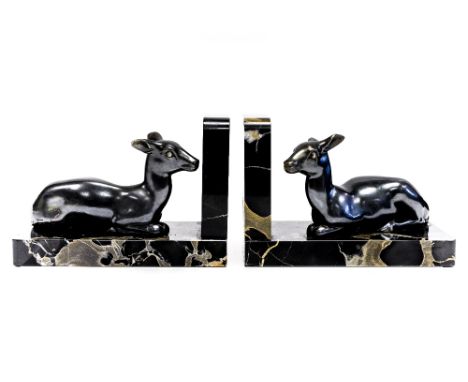 A pair of French Art Deco bronzed bookends, in the form of recumbent deer, on marble bases, signed M Font, 11cm high (2) 