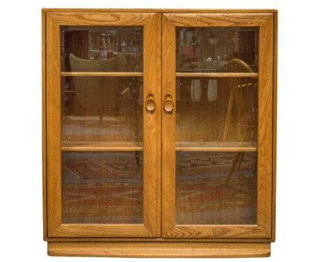 An Ercol Windsor glazed bookcase, two double doors and a shelved interior, 91cm wide, 97cm high, 29cm deep