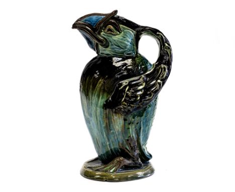 C H Brannam, Barum, an Art Pottery grotesque bird jug, 1907, majolica glazed in green and brown, modelled as a puffin type bi