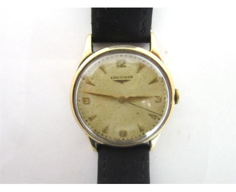 LONGINES, A GENTLEMANS 9 CARAT GOLD WRISTWATCH Birmingham 1957, the signed circular dial with gilt dagger batons, Arabic nume