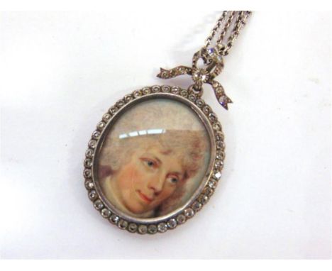 A PASTE SET PICTURE PENDANT  the oval frame, containing a miniature portrait with a paste set bow surmount, 5cm long overall,