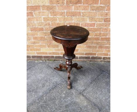 A VICTORIAN WORK TABLE the circular lid opening to reveal a fitted interior and raised on tripod cabriole supports, 46cm diam