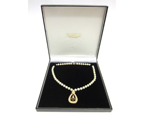 A RUBY AND DIAMOND PENDANT  to a uniform row of cultured pearls, indistinct marks, the central diamond of approximately 0.25 