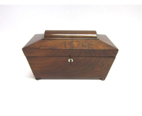 A VICTORIAN ROSEWOOD TEA CADDY, of sarcophagus form with compressed bun feet, 29.5cm wide 15.5cm deep 17.5cm high