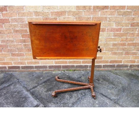 AN OAK AND CAST IRON ADJUSTABLE TABLE, the rectangular top with label for 'CARTERS BY APPOINTMENT TO H M THE KING', on decora