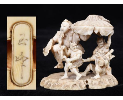 A JAPANESE CARVED IVORY OKIMONO NETSUKE Meiji period, depicting a dancing man, holding a fan and supporting an umbrella, alon