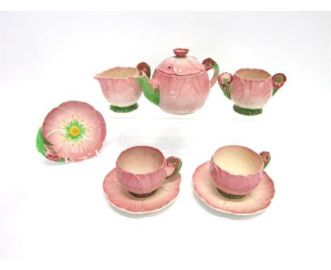 A CARLTON WARE TETE A TETE TEA SERVICE with naturalistic floral moulded decoration, the teapot 11cm high