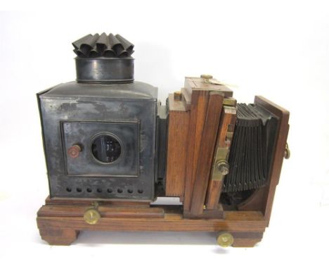 A THORNTON-PICKARD ENLARGER the oak body with extending bellows, lacquered brass fittings, and a tin light box, 61cm long (un