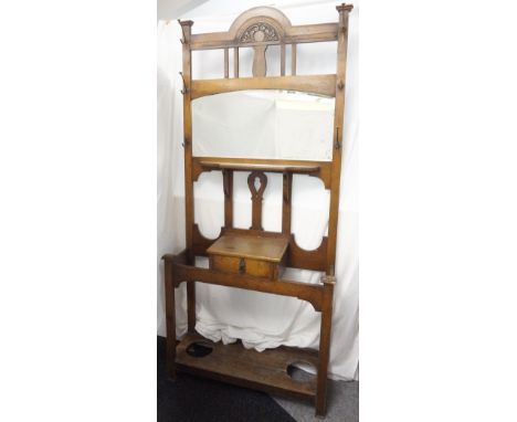 LATE VICTORIAN OAK MIRRORED HALLSTAND
with shaped top above mirror and shelf, single drawer compartment and stick stand eithe