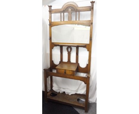 LATE VICTORIAN OAK MIRRORED HALLSTAND
with shaped top above mirror and shelf, single drawer compartment and stick stand eithe