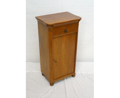 CONTINENTAL STAINED PINE BEDSIDE CUPBOARD
with a serpentine top above a frieze drawer and cupboard door opening to reveal an 