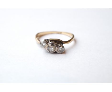 VICTORIAN DIAMOND THREE STONE RING
on eighteen carat gold shank with twist setting, the diamonds totalling approximately 0.2c