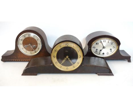 GERMAN MAHOGANY CASED MANTLE CLOCK
with an oval silvered dial with Arabic numerals, standing on bracket feet; an oak cased ma