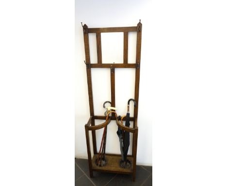 1920's OAK HALLSTAND
the upper central rectangular mirror flanked by hooks, with shaped stick stands below, raised on straigh