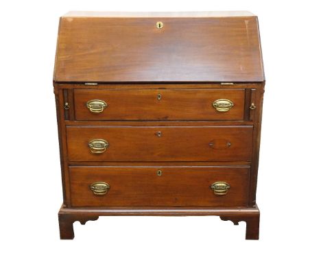 GEORGE III MAHOGANY BUREAU
the fall flap revealing an arrangement of pigeon holes and drawers, with a central recess flanked 