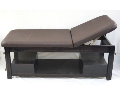 MASSAGE BED
with two section mat and adjustable backrest, raised on stout wooden frame with two fitted drawers sitting on low