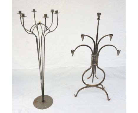 WROUGHT IRON FLOOR STANDING CANDELABRA 
of tapering form with a central brass finial surrounded by six shaped arms, standing 