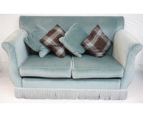 TWO SEAT SOFA
with shaped arms in a light blue plush material, with four loose cushions, on castors, 172cm wide 