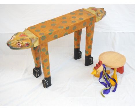 GROTESQUE PAINTED WOODEN ANIMAL BENCH
with two cat like heads, together with a small child's stool modelled as a chicken 