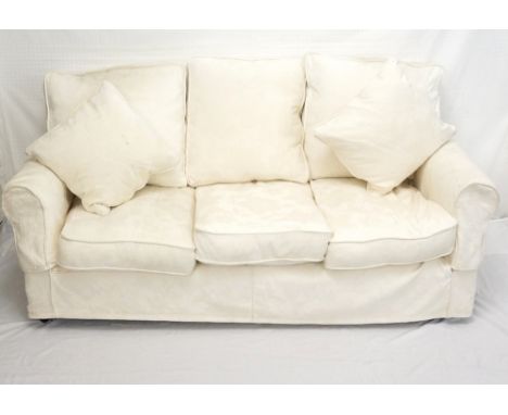 PETRINA THREE SEAT SOFA
in a cream floral material with two sets of loose covers, on castors, approximately 180cm wide