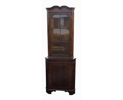 MAHOGANY CORNER CUPBOARD
the shaped top above a glazed door with a shelved interior, the lower section with a cupboard door, 