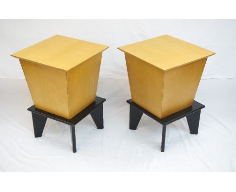 PAIR OF LIGHT OAK PLANTERS
of square tapering form with lids, standing on plinths, 66cm high overall