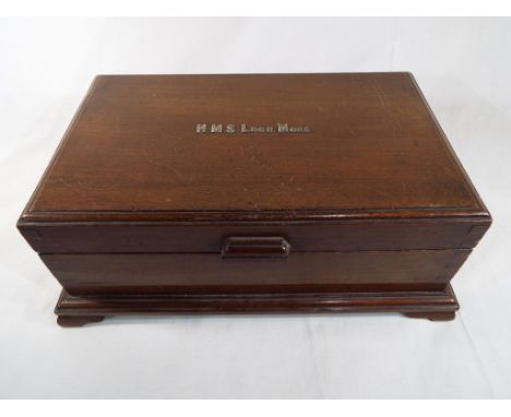 H.M.S. Loch More - a mahogany chest with fitted interior raised on bracket feet, the hinged lid with applied white metal lett