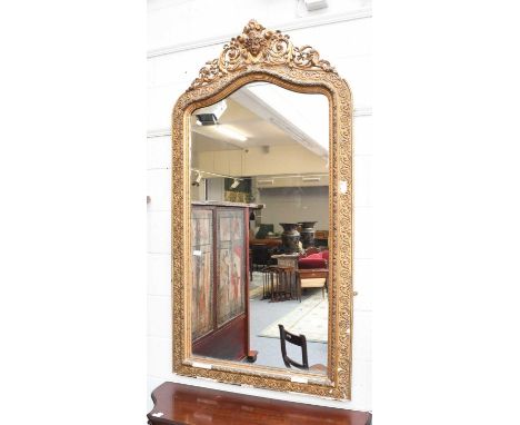 A 19th Century Gilt Framed Mirror, with scroll and mask surmount, 92cm by 172cm