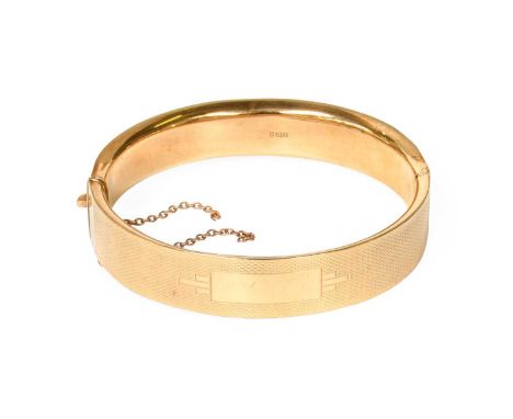 A 9 Carat Gold Hinged Bangle, inner measurements 5.8cm by 5.1cmGross weight 20.3 grams.