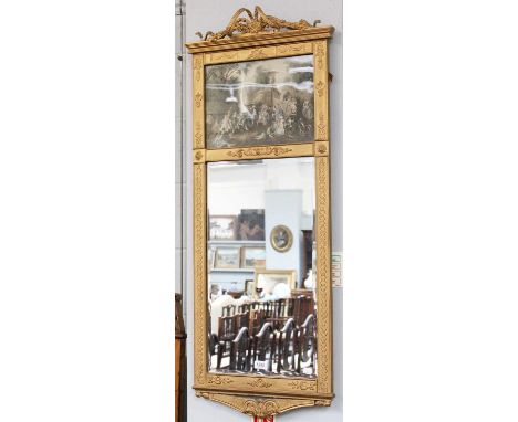 An early 20th century Gilt Bevelled Glass Mirror, the ribbon tied pediment with printed panel depicting figures in a landscap