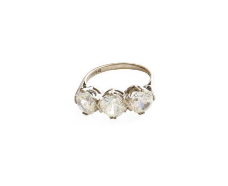 An 18 Carat Gold Colourless Three Stone Ring, finger size RGross weight 6.3 grams.