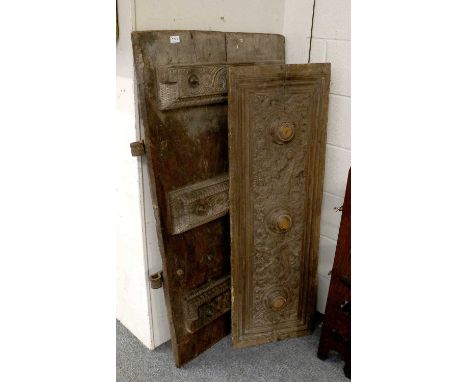 An 18th Century Indian Carved Hardwood Door, with iron ring mounts, together with a similar panel, door 80cm by 140cm, panel 