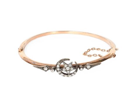 A Diamond Bangle, the yellow plain polished hinged bangle overlaid with a star and crescent motif set throughout with old cut