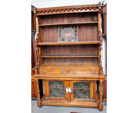 A Victorian Oak Puginistic Dresser, with leaded glass doors, 143cm by 60cm by 220cmDoes come in two sections to transport, on