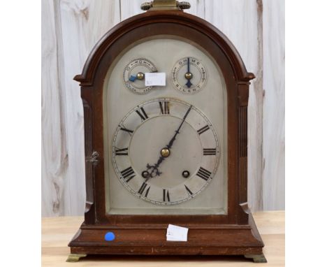 An early 20th Century 8 day mahogany mantle clock, silver faced with Roman numerals.