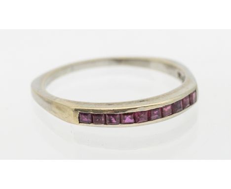 A ruby and 14ct white gold ring, comprising a row of ten channel set calibre cut rubies, width approx 3mm, size W1/2, total g